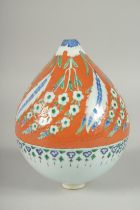 AN OTTOMAN TURKISH KUTAHYA GLAZED POTTERY HANGING ORNAMENT, 20cm high.