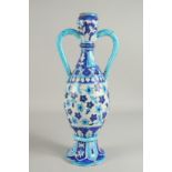 AN ISLAMIC BLUE AND WHITE GLAZED POTTERY VASE, with twin handles, 44.5cm high.