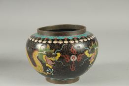 A CHINESE CLOISONNE BLACK GROUND DRAGON BOWL, with two dragons and the flaming pearl of wisdom, 15cm