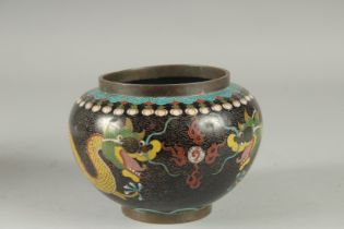 A CHINESE CLOISONNE BLACK GROUND DRAGON BOWL, with two dragons and the flaming pearl of wisdom, 15cm