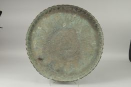 A LARGE MIDDLE EASTERN ENGRAVED METAL TRAY, 61cm diameter.