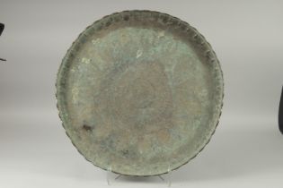 A LARGE MIDDLE EASTERN ENGRAVED METAL TRAY, 61cm diameter.