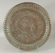 AN ISLAMIC ENGRAVED TINNED COPPER DISH, with bands of calligraphy, 56cm diameter.