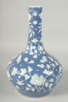 A CHINESE BLUE GROUND PORCELAIN VASE, with carved floral decoration in white, 34cm high.