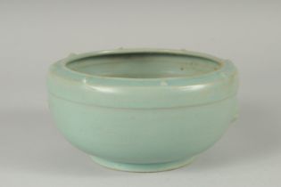 A CHINESE CELADON GLAZE PORCELAIN BOWL, the sides with moulded handles and rim with raised bosses,