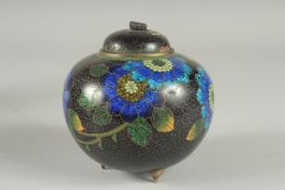 A CHINESE BLACK GROUND CLOISONNE JAR AND COVER, with glittered enamel flowers, 11cm high.