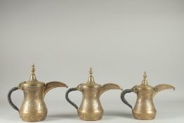 THREE EYGPTIAN CAIROWARE SILVER AND COPPER INLAID BRASS COFFEE POTS, of graduating sizes, each