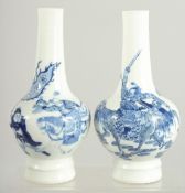 A FINE PAIR OF CHINESE BLUE AND WHITE PORCELAIN BOTTLE VASES, one painted with a warrior riding a