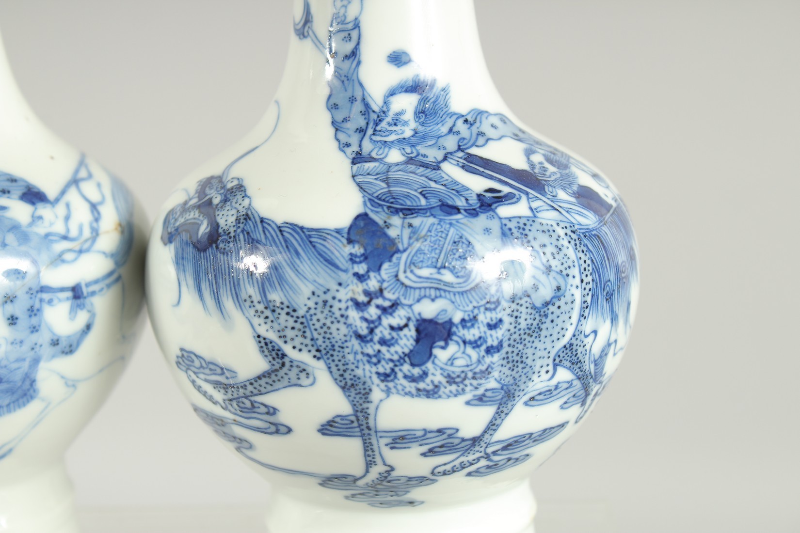 A FINE PAIR OF CHINESE BLUE AND WHITE PORCELAIN BOTTLE VASES, one painted with a warrior riding a - Image 6 of 8