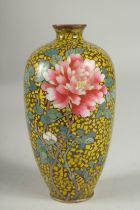 A JAPANESE YELLOW GROUND GLITTERED ENAMEL CLOISONNE VASE, decorated with a flower, with character