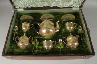 A FINE EARLY 20TH CENTURY INDIAN ENGRAVED SILVER TEA SERVICE, in presentation case, comprising a