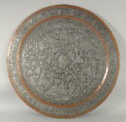 A VERY LARGE ISLAMIC ENGRAVED TINNED COPPER TRAY, with raised engraved decoration depicting