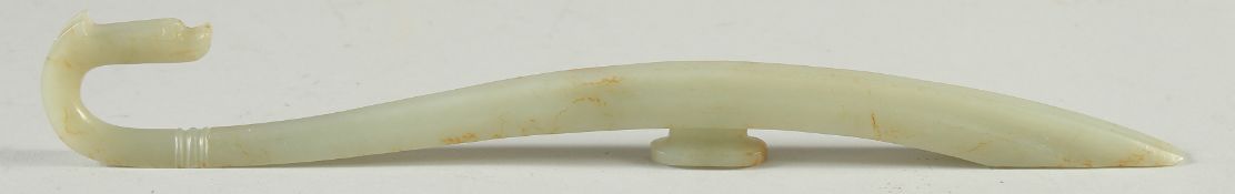A LONG CARVED JADE BELT HOOK, with dragon head, 25.5cm long.