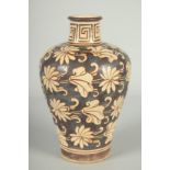 A CHINESE JIZHOU KILN POTTERY VASE, with lilipad and flower head decoration, 19cm high.