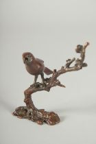 A JAPANESE BRONZE OKIMONO OF A BIRD ON A BRANCH.