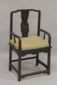 A GOOD 19TH CENTURY CHINESE REDWOOD ARMCHAIR, with curving top rail, carved central splat, solid