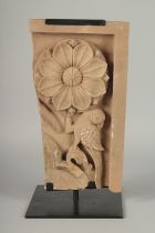 A FINELY CARVED MUGHAL INDIAN STONE PANEL ON A METAL STAND, stone 40cm x 22.5cm.