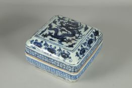 A CHINESE BLUE AND WHITE PORCELAIN SQUARE-FORM BOX AND COVER, decorated with a dragon and floral
