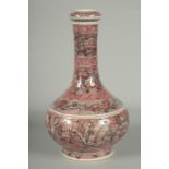 A CHINESE IRON RED AND WHITE GLAZE PORCELAIN BOTTLE VASE, painted with foo dogs and various