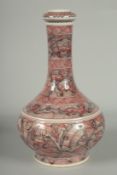 A CHINESE IRON RED AND WHITE GLAZE PORCELAIN BOTTLE VASE, painted with foo dogs and various