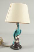 A CHINESE TURQUOISE GLAZE PORCELAIN PEACOCK PHOENIX, converted to a lamp base and mounted to a