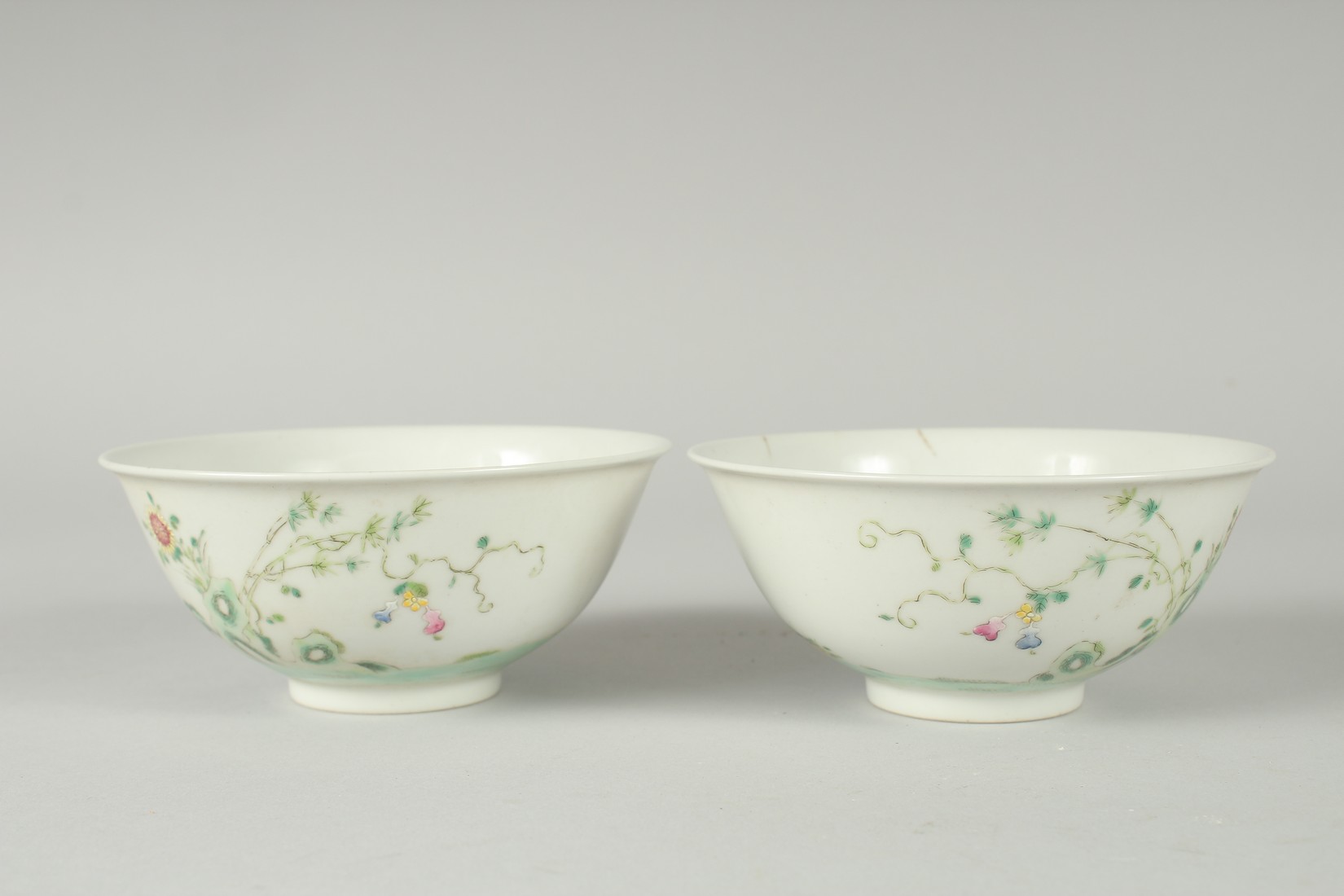 A PAIR OF EARLY 20TH CENTURY FAMILLE ROSE PORCELAIN RICE BOWLS, painted with boys, each with red - Image 3 of 6