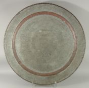 A VERY LARGE ISLAMIC ENGRAVED TINNED COPPER TRAY, 78cm diameter.