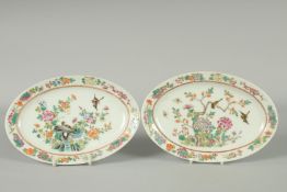 A PAIR OF CHINESE FAMILLE ROSE PORCELAIN OVAL DISHES, painted with birds and flora, each with red