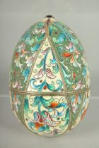 A RUSSIAN SILVER AND ENAMEL EGG 9cm long. 6cm diameter. Mark: Head, A.O. over 1891.