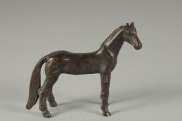 A CAST BRONZE HORSE. 3cm long.
