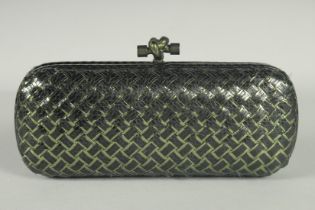 A BOTTEGO VENETO BLACK AND CREAM CLUTCH BAG. 9ins long with dust bag.