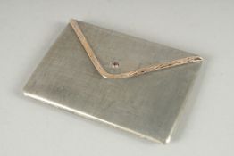 A STERLING SILVER 18CT GOLD AND RUBY MOUNTED COMPACT, in the form of an envelope. 3.25ins x 2.