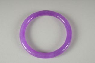 A LAVENDER JADE BANGLE. 7cm diameter.