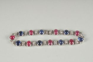 A VERY GOOD 18CT WHITE GOLD RUBY, SAPPHIRE AND DIAMOND LINE BRACELET.