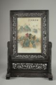 A CHINESE PORCELAIN TABLE SCREEN in a wooden frame. Screen: 14ins x 9.5ins.