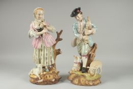 A LARGE PAIR OF PORCELAIN GROUPS OF A GALLANT AND A YOUNG LADY, sheep at her feet. 16.5ins high.