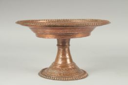A TURKISH HAMMERED COPPER TAZZA. 11ins diameter, 6.5ins high.