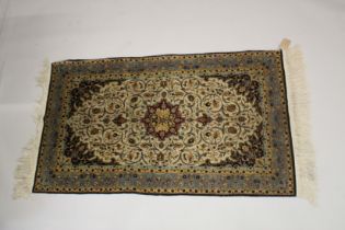 A GOOD SMALL PERSIAN SILK RUG beige ground with all over stylised decoration. 5ft x 3ft.