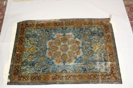 A FINE PERSIAN SILK RUG turquoise ground with stylised motifs and medallions. Signed. 6ft 6ins x 4ft