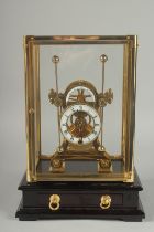 A GRASSHOPPER SKELETON CLOCK in a glass case. 13ins high overall.