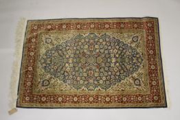A GOOD SMALL PERSIAN BLUE RUG blue and beige ground with stylised floral decoration. 5ft ins x 3ft