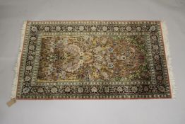 A PERSIAN PART SILK RUG salmon ground decorated with a vase of flowers and birds. 5ft 5ins x 3ft