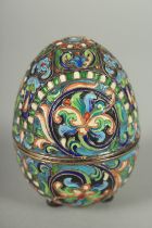 A RUSSIAN SILVER AND ENAMEL EGG. 7cm high, 5cm diameter. Mark: 84. Weight: 62gms.