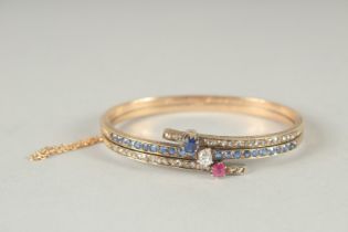 A SUPERB 18CT YELLOW GOLD SAPPHIRE, RUBY AND DIAMOND CROSSOVER BRACELET with inscription, dated