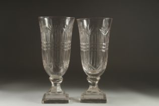 A GOOD PAIR OF CUT GLASS VASES on stepped square bases. 11.5ins high.