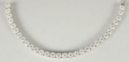 A SUPERB 18 CARAT WHITE GOLD ILLUSION SET DIAMOND LINE BRACELET with 30 cluster set diamonds. 20cm