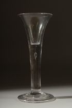 A GEORGIAN GLASS with tapering bowl and tear drop in the stem. 6.5ins high.