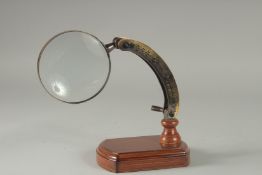 A MAGNIFYING GLASS on a stand.