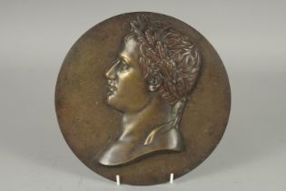 AFTER THE ANTIQUE. A BRONZE CIRCULAR PLAQUE "A ROMAN HEAD''. 9ins diameter.