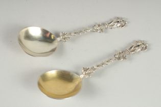 A PAIR OF SILVER SPOONS, with entwined stems, the terminal as a pair offigures. London 1865. 6.75ins